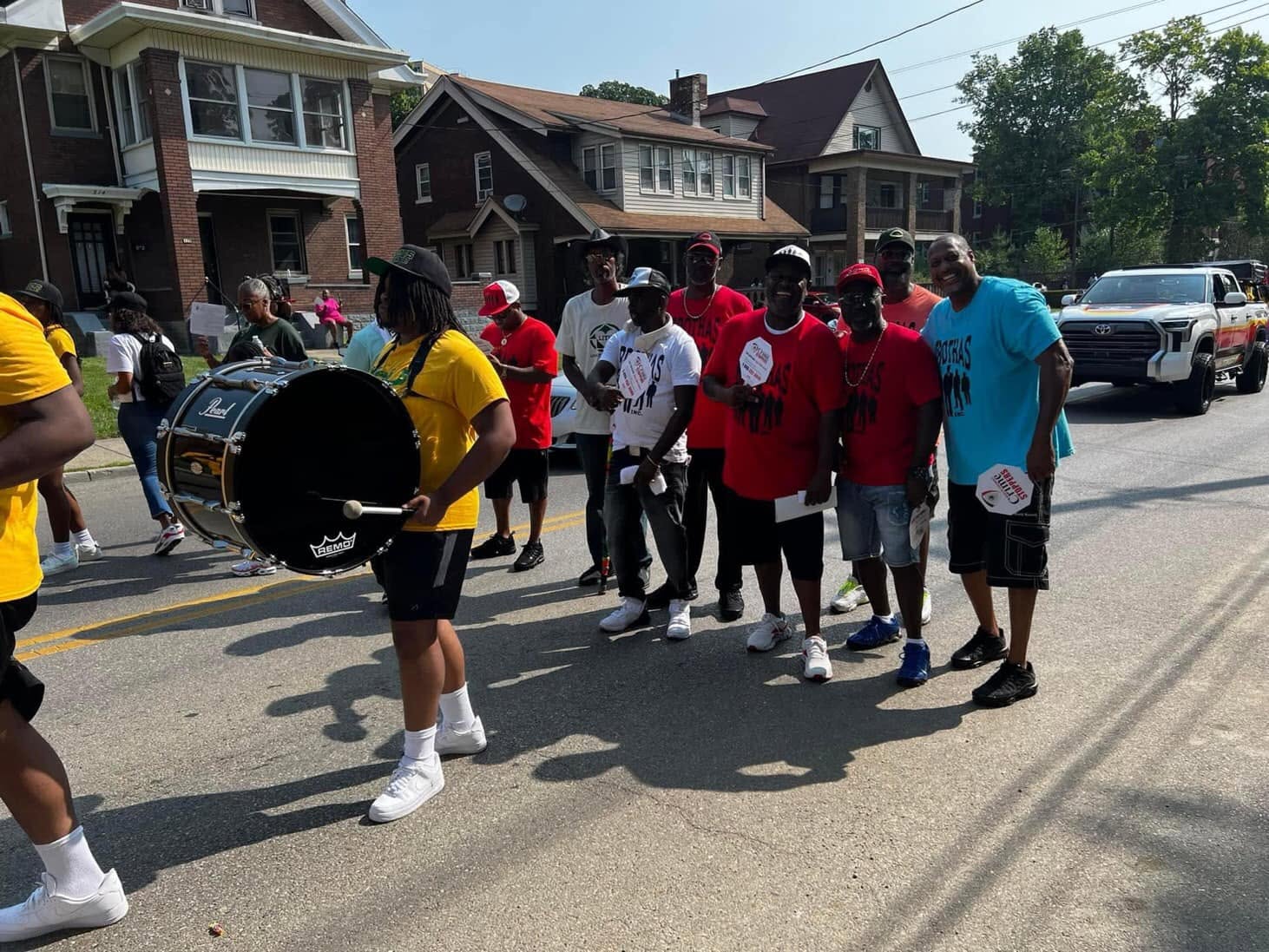 Drummer with Pearl bass drum next to Brothas Inc. mentors on the Black Family Reunion Parade route