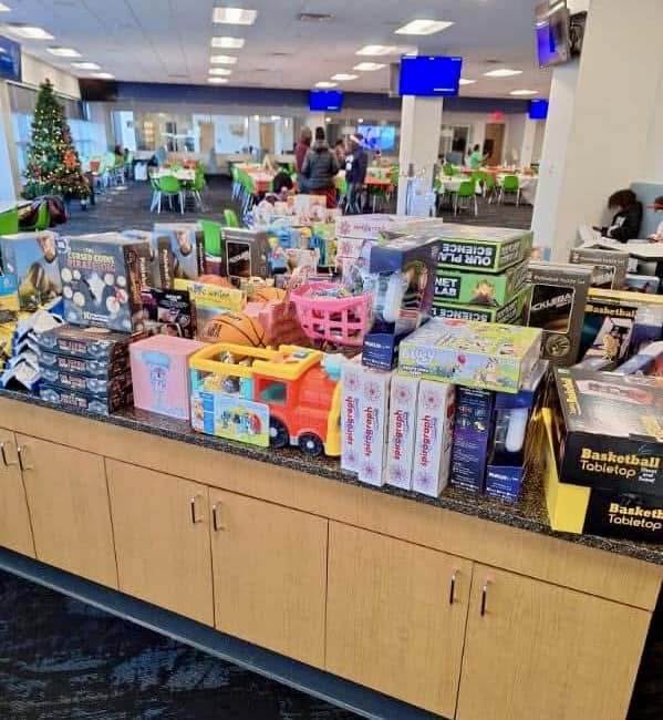Table stacked with donated toys and games ready for families at Jingle Jam 2024