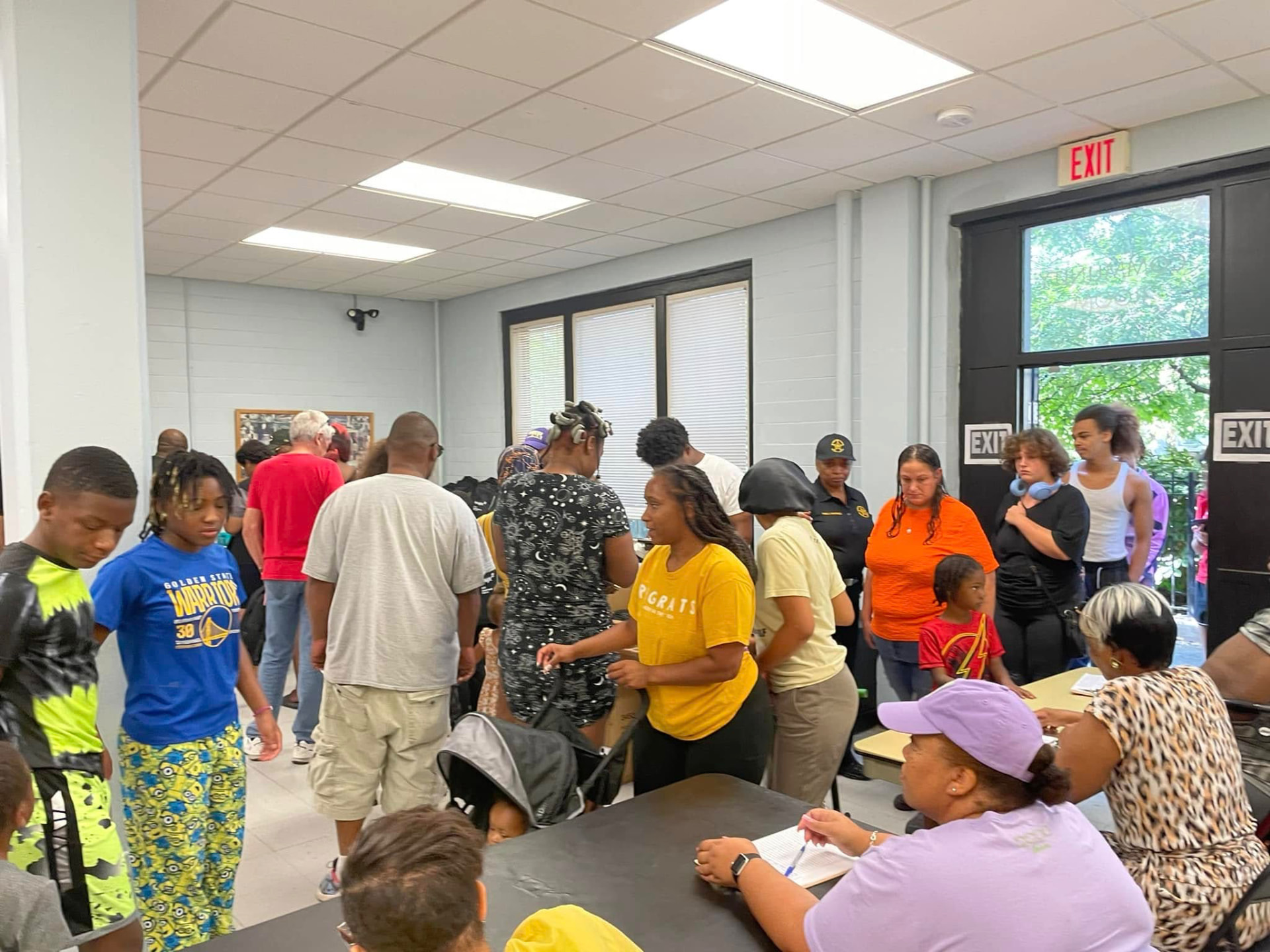 Families and youth lined up inside at the registration tables during the 2024 Backpack Giveaway