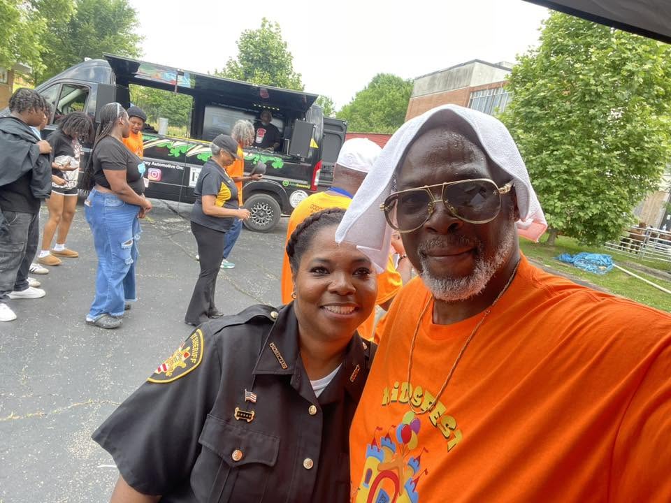 Sheriff deputy and Brothas Inc. founder smiling for a selfie at 3rd KidsFest