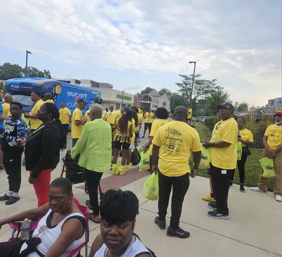 Large crowd in yellow Closing The Health Gap shirts gathered at the Black Family Reunion 2024