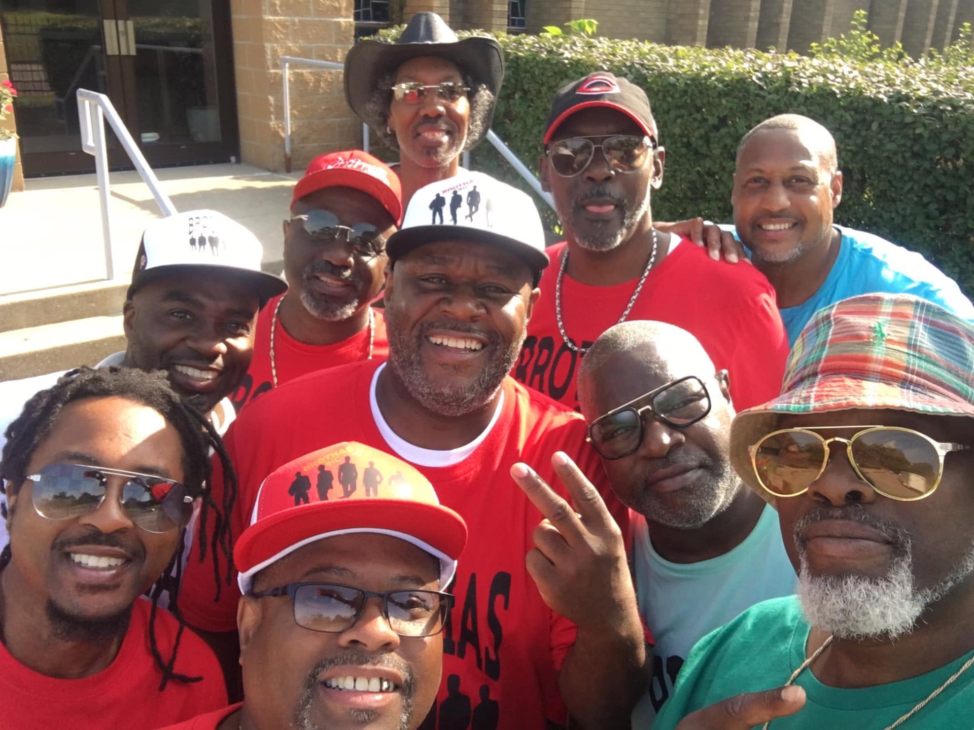 Group selfie of Brothas Inc. mentors in red shirts at the Black Family Reunion