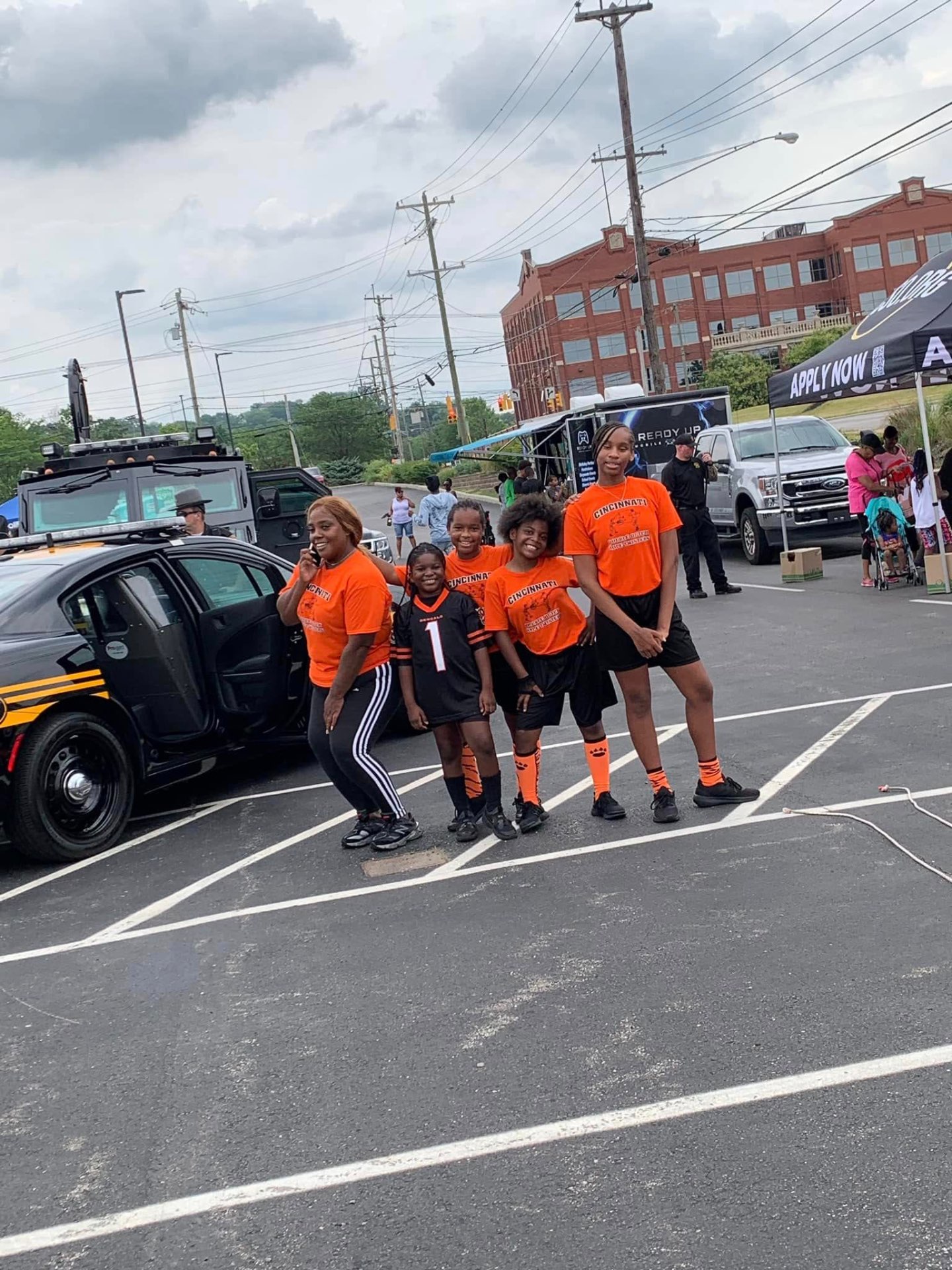 Youth football team in orange Bengals gear posing at 2nd KidsFest