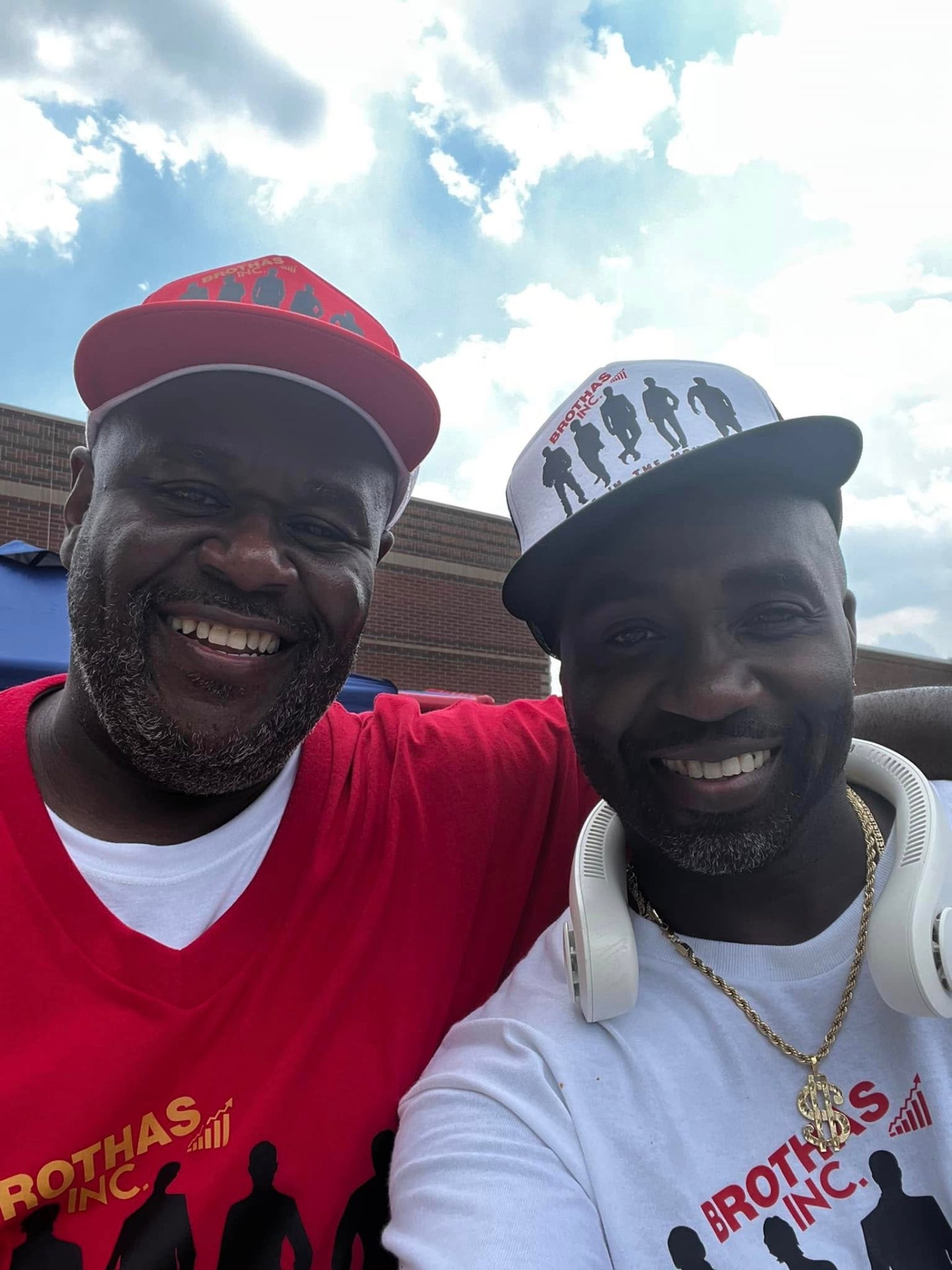 Two Brothas Inc. members smiling in branded gear at KidsFest