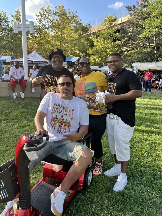Brothas Inc. supporters gathered on the lawn at the Black Family Reunion 2024, including a member on a mobility scooter