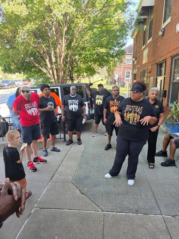 Brothas Inc. team members in branded shirts gathering outside before the 2025 Backpack Giveaway