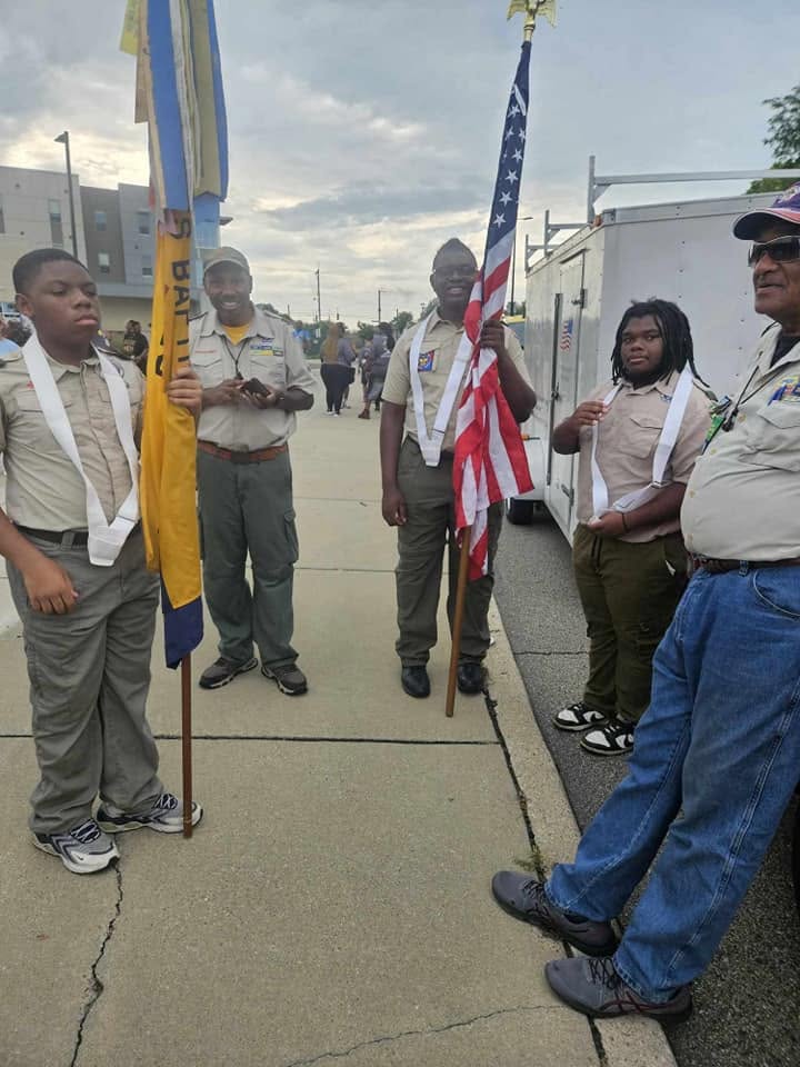 Young scouts holding the American flag and unit banner at the Black Family Reunion 2024 opening ceremony