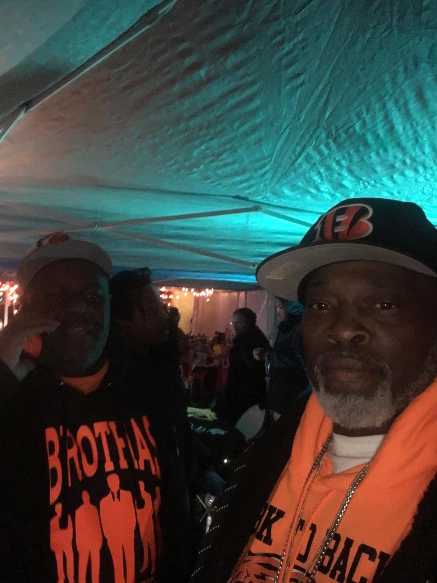 Brothas Inc. supporters in Bengals gear taking a selfie under the tent at Jingle Jam 2023