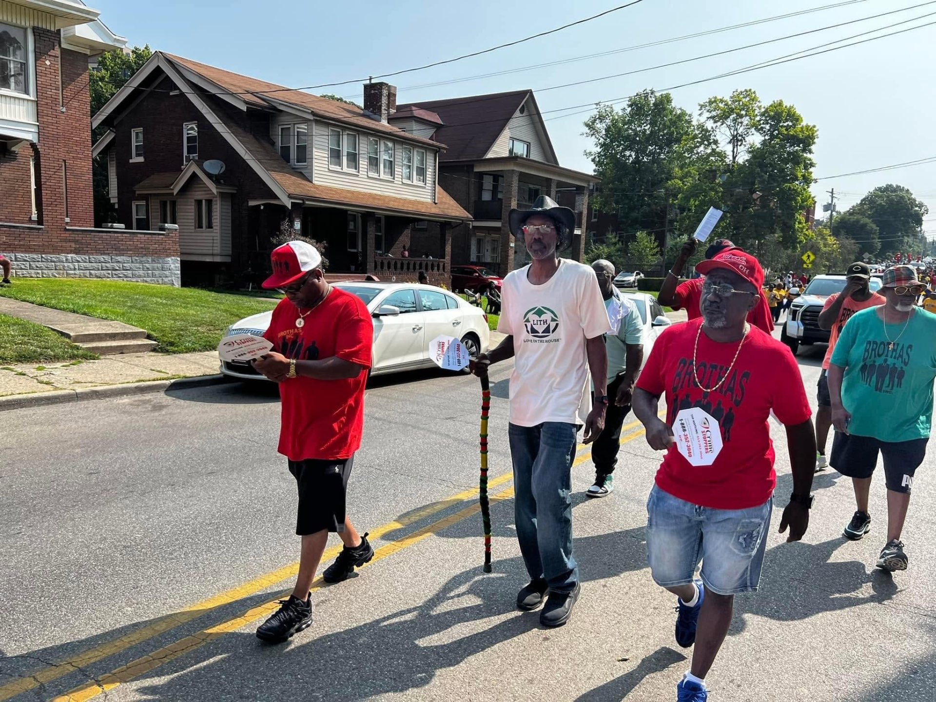 Three Brothas Inc. elders walking together with a rasta cane at the Black Family Reunion Parade