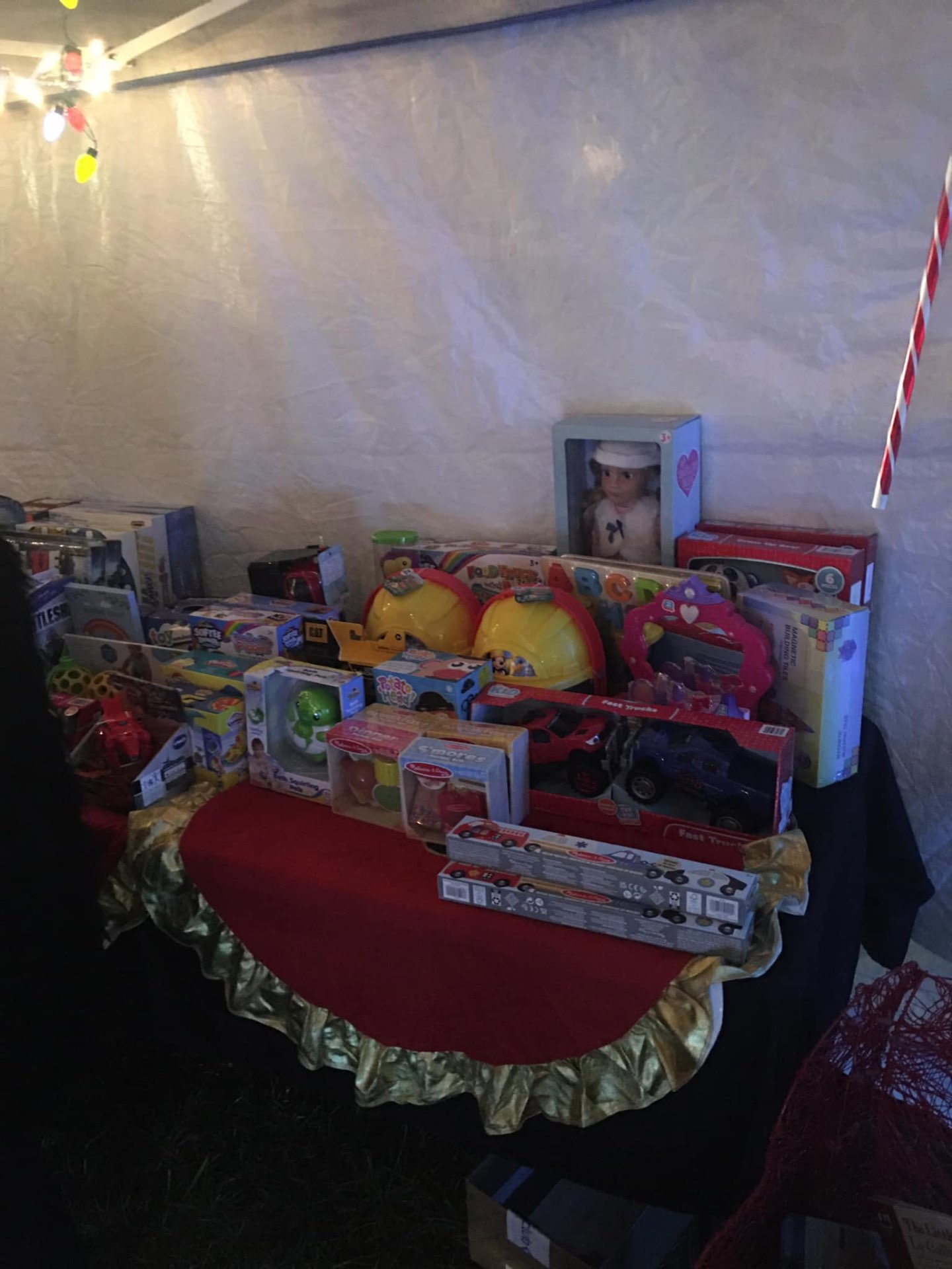 Table full of donated toys and games ready for families at Brothas Inc. Jingle Jam 2023 giveaway