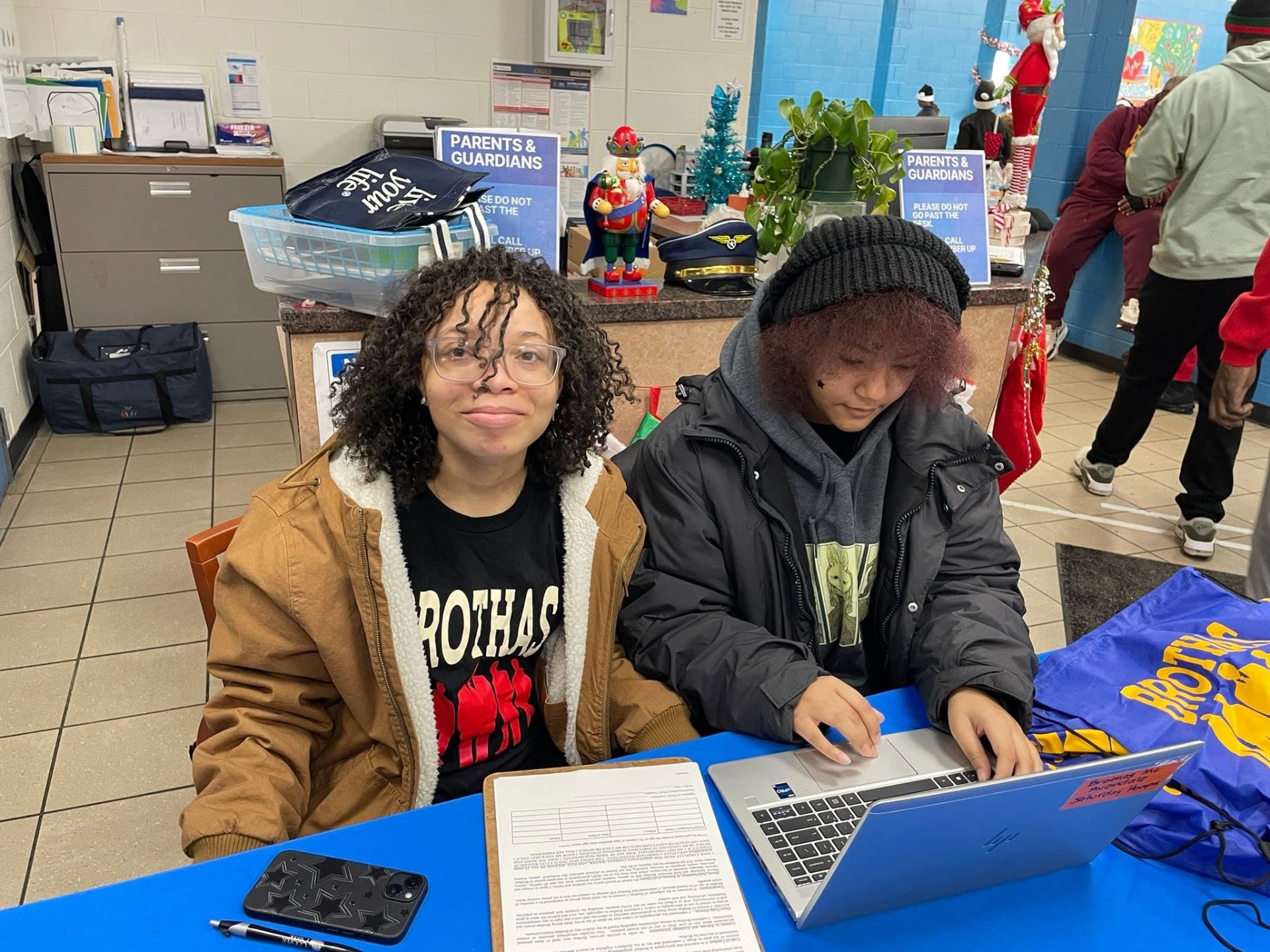 Two Brothas Inc. volunteers running the registration table at Jingle Jam 2025
