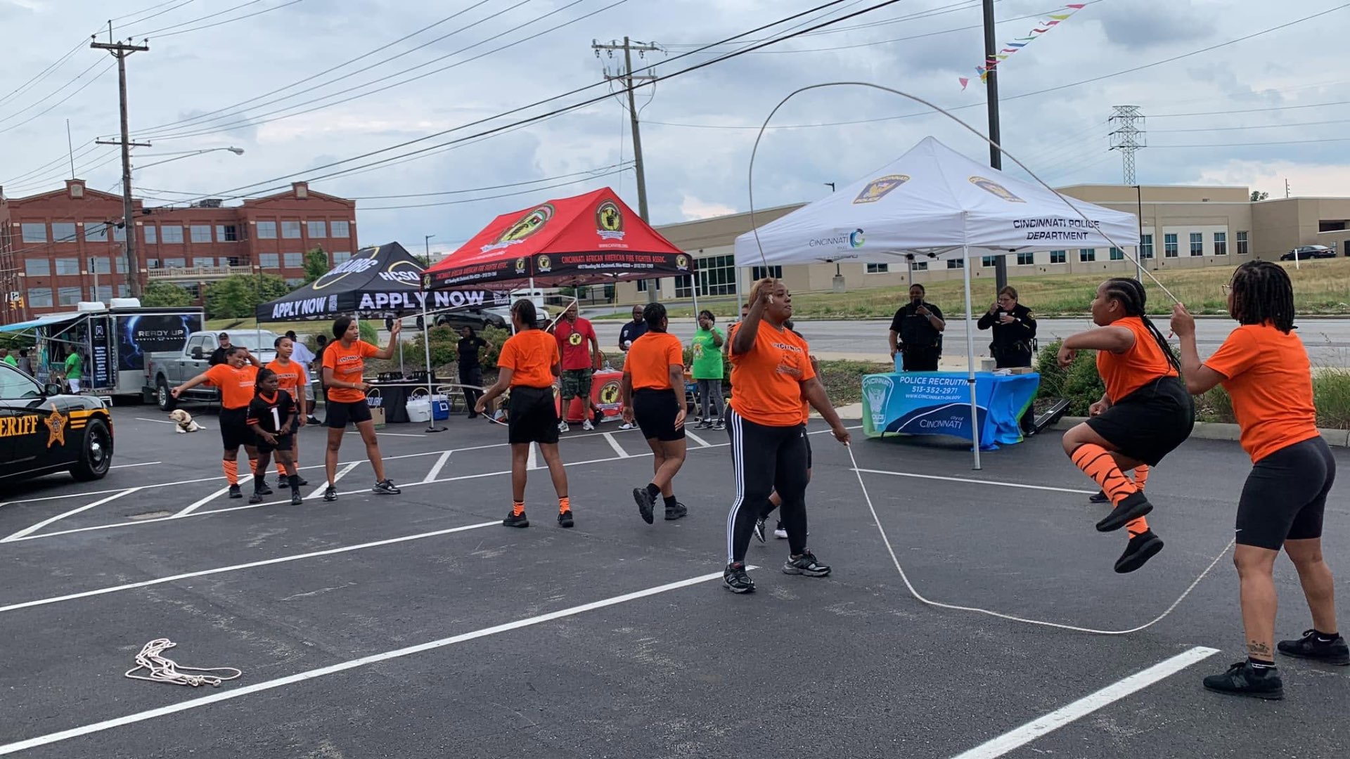 Girls in orange shirts performing double dutch jump rope at 2nd KidsFest