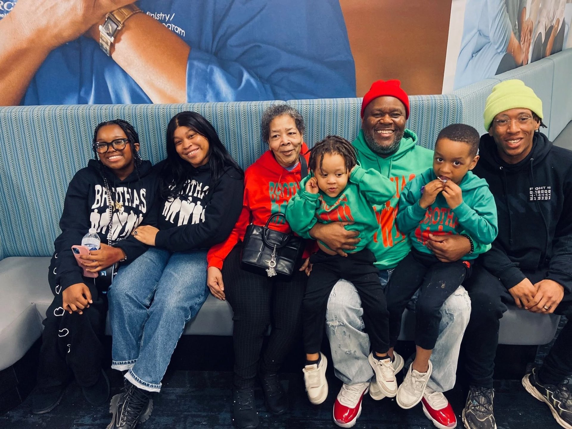 Multi-generational family in Brothas Inc. gear posing together at Jingle Jam 2024