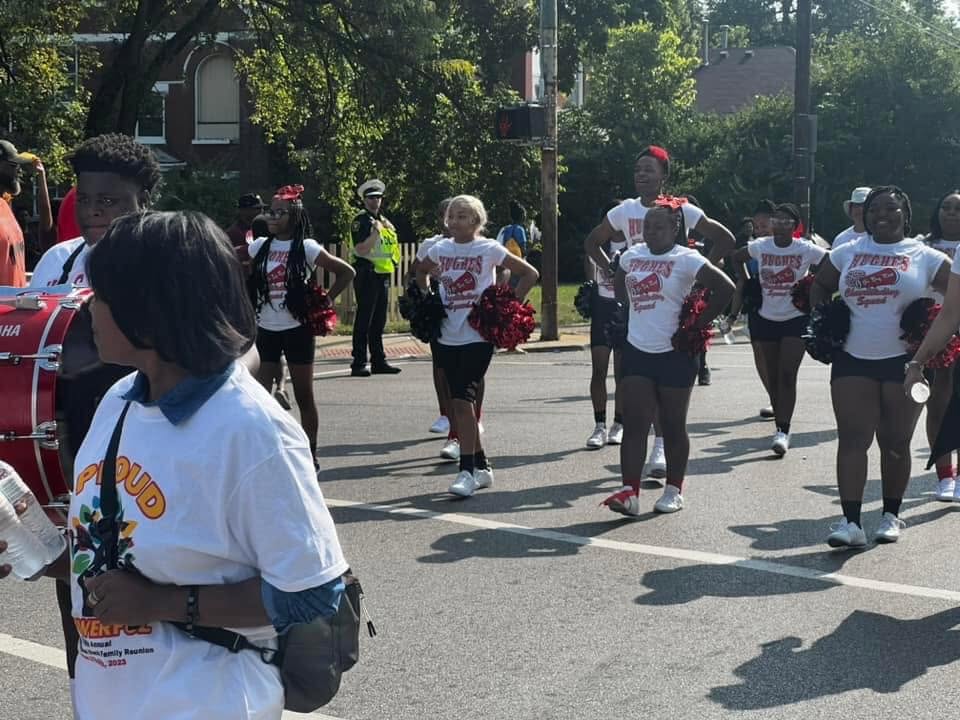 Hughes High cheerleading squad performing in the street at the Black Family Reunion Parade