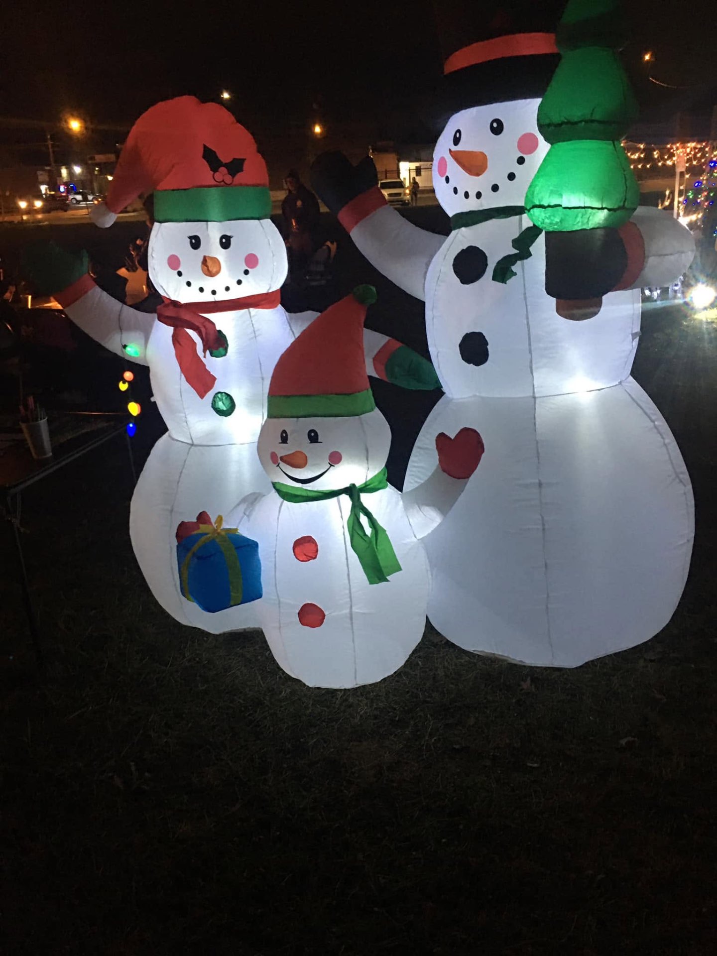 Family of light-up inflatable snowmen glowing after dark at Brothas Inc. Jingle Jam 2023