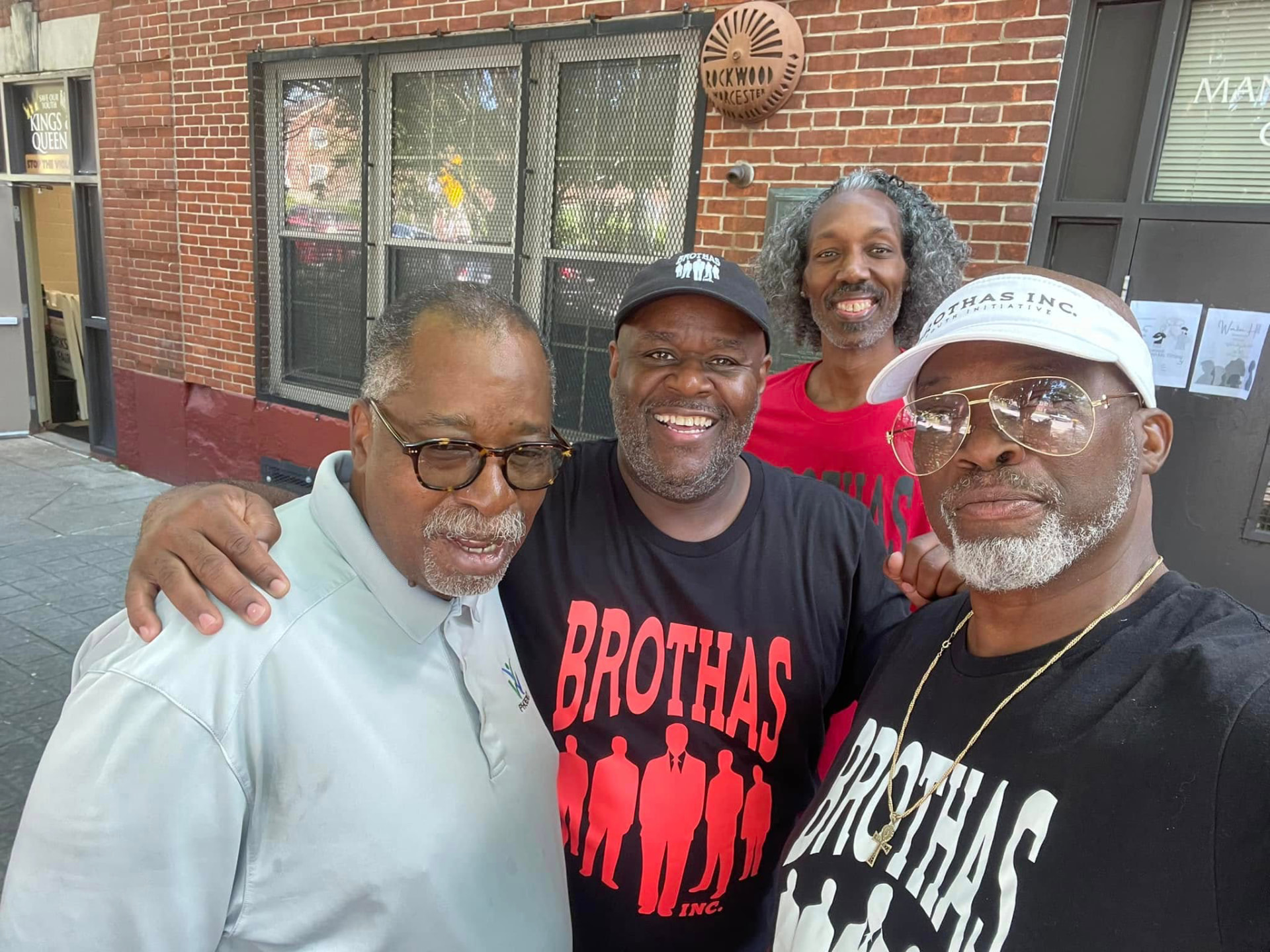 Four Brothas Inc. leaders in Brothas Inc. shirts posing together at the 2024 Backpack Giveaway