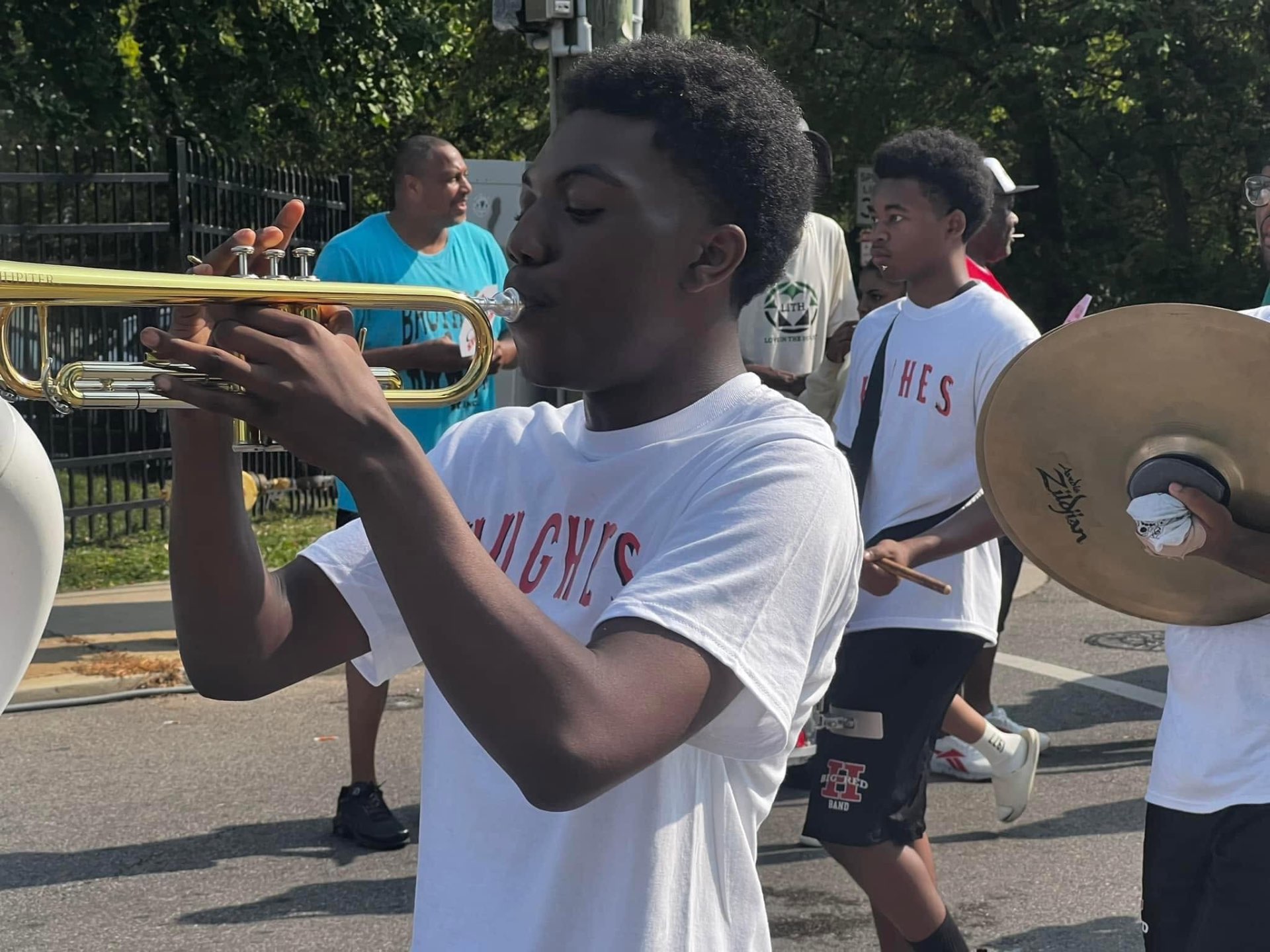 Hughes High School student playing trumpet in the Black Family Reunion Parade