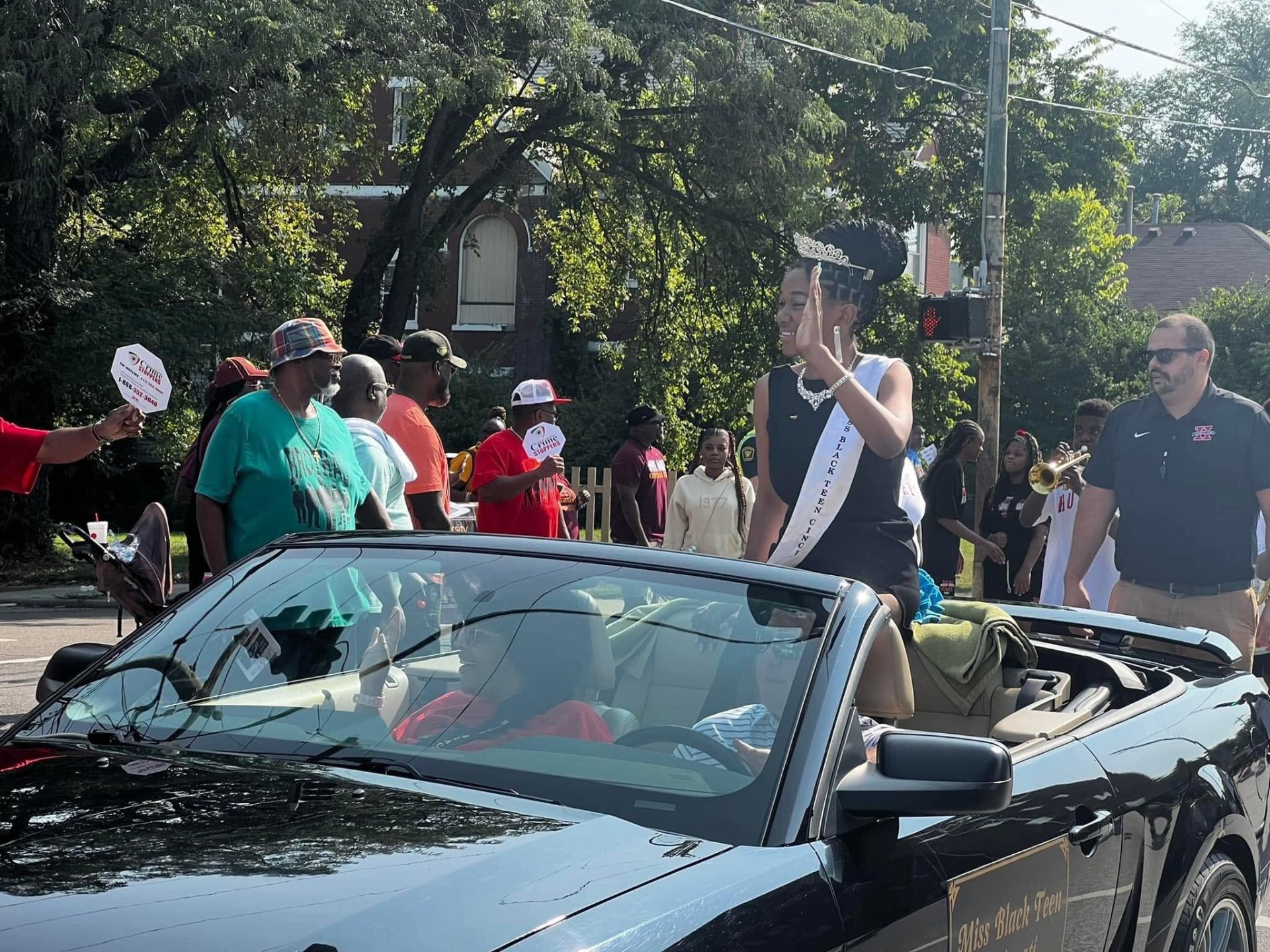 Miss Black Teen Cincinnati waving from a convertible during the Black Family Reunion Parade