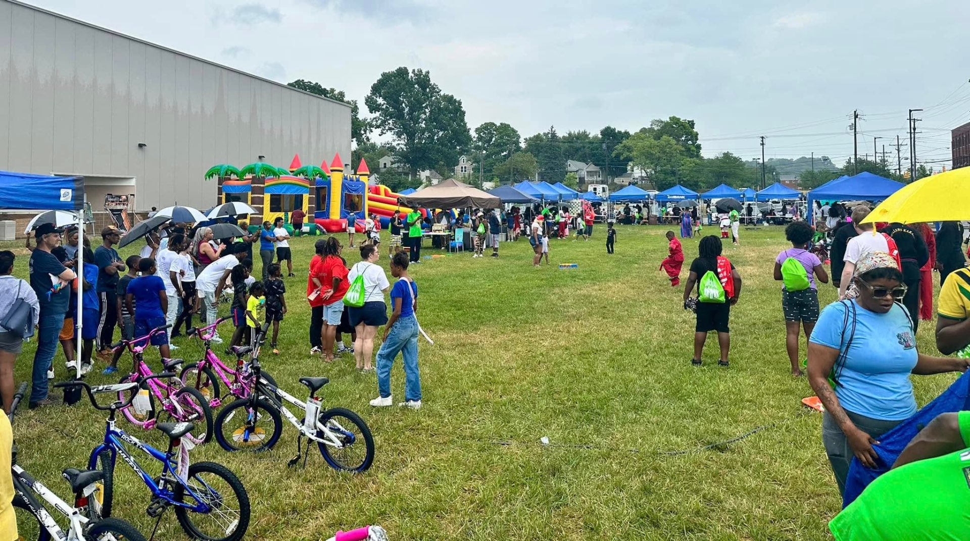 Crowd of families beside a row of new bikes at 2nd KidsFest