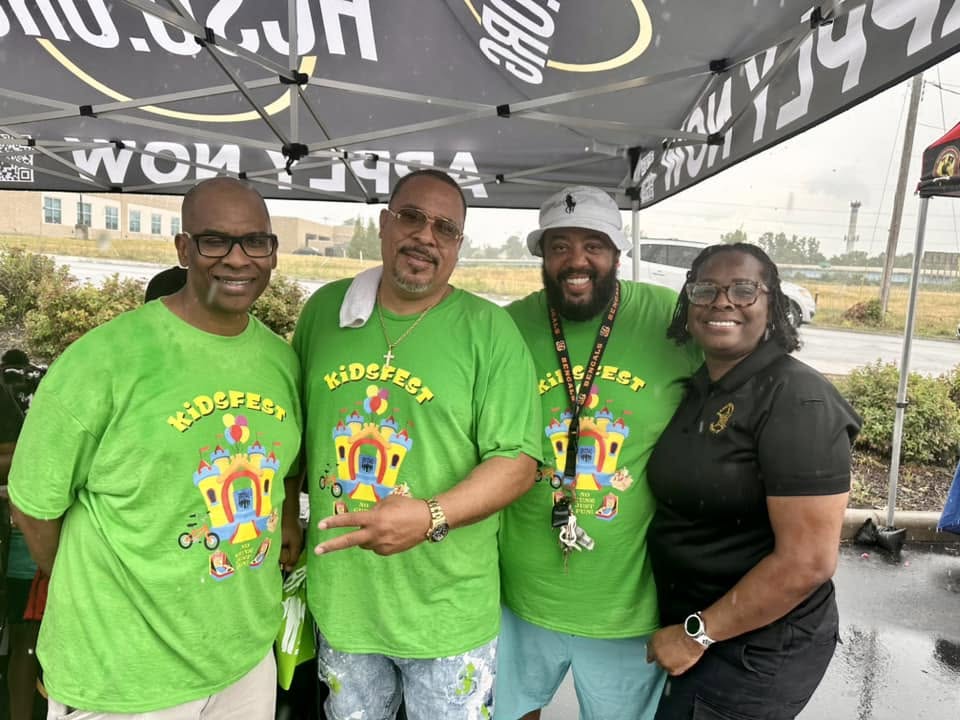 Brothas Inc. team in green KidsFest shirts posing together