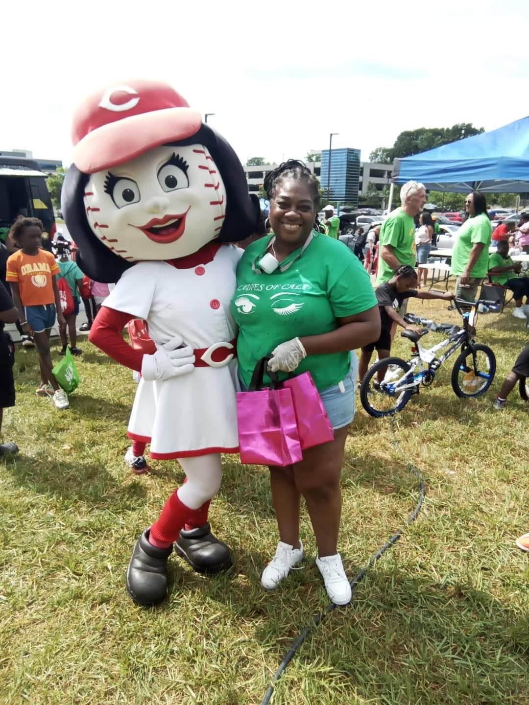 Ladies of Cali volunteer posing with Rosie Red mascot at 2nd KidsFest