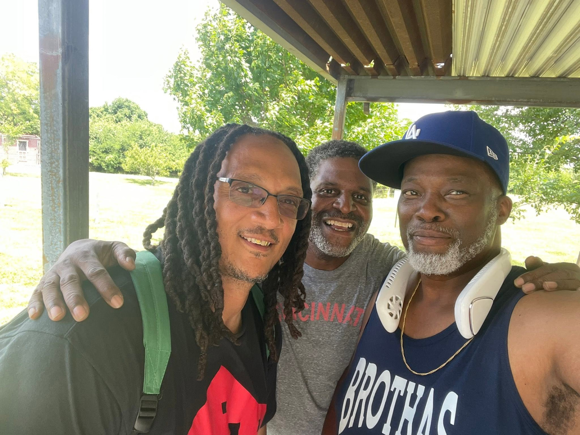 Three Brothas Inc. mentors taking a selfie together under the shelter at Saturday Hoops