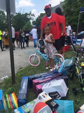 Child receiving a bike at the KidsFest giveaway